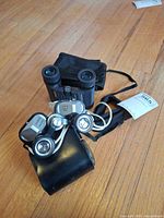 Both binoculars with cases shown together