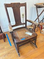 Front angled view of child oak rocking chair
