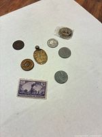 Group view of all coins, medallion and stamp