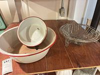 Large enamel basin, small enamel bowl, and one wire basket on shelf