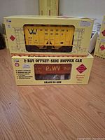 Two boxed Aristo-Craft G-scale hopper cars stacked