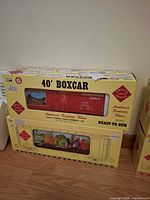 Both boxed Aristo-Craft 40' boxcars stacked, Altoona Brewing box visible