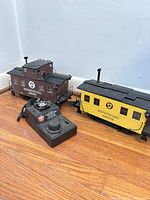 Two cabooses coupled together with Crest controller in foreground