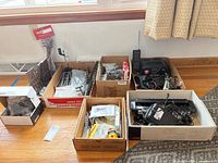 Overall view of multiple boxes containing power supply, tracks, couplers, wheels, decals, LED light