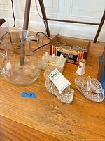 Group view: glass pitcher, box of shakers, pressed glass dishes, ceramic shaker