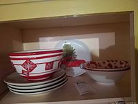 Stack of Noritake plates, Boyds snowflake bowl above, holiday bowl and melamine plate shown
