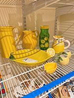Full group of lemon-themed serveware on shelf