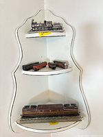 Full view of all six train items on three-tier corner shelf