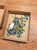 Top view of cardboard tray containing full assortment of marbles
