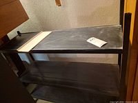 Full view of three-shelf metal unit