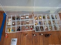 Overview of two compartment cases with miniatures and loose pieces