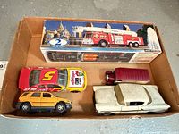 overview of boxed fire engine and four loose cars in cardboard tray