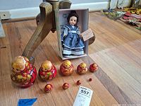 Full lot view showing nested doll set lined up by size and boxed Meg doll