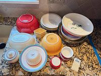 Group shot of all bowls, platter, ramekins and sugar jar on countertop