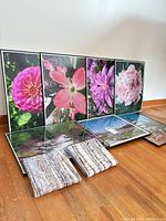 Overview of all nine photo art pieces arranged on floor and leaning against wall