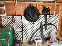 Lattice panel mounted against shed wall with other items around