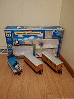 Set showing Thomas locomotive, Annie and Clarabel coaches, original box
