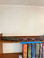 Full shelf view showing locomotive and four boxcars