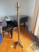 Full view of wooden coat rack front side