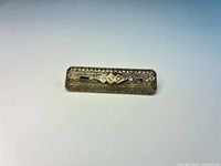 Top view of filigree bar pin showing stones and filigree detail