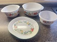Group shot of three stoneware pieces and one platter