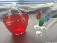 Group shot showing red purse vase and three colored stemmed glasses