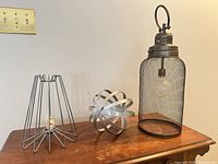 All three metal decor pieces on table