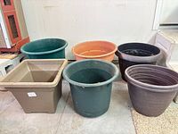Group of six visible planters assorted shapes and colors