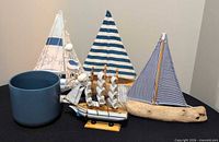 Group shot of four sailboat models and ceramic planter
