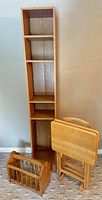 Full lot showing tall shelf, two folding tables on stand, magazine rack