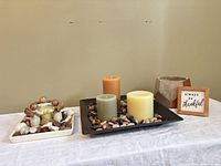 Overall view of both decorative plates with contents, planter and framed sign