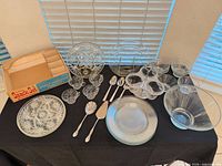 Overall lot showing snack set box, Prescut platter, cups, plates, bowls, tier stand, utensils