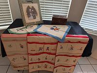 Group shot showing carved box, framed art, hanging organizer and linens
