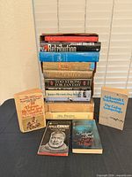 Front view showing entire stack plus additional front-row books