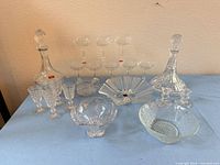 Group shot displaying decanter, coupe glasses, cordial glasses, Mikasa bowl, candlesticks, and additional bowls