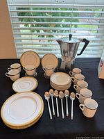Full lot showing Moka pot, cups, saucers, plates and spoons