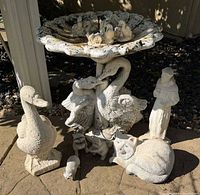Full view of swan birdbath with additional statues around base