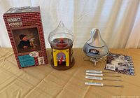 Full lot: boxed dispenser, assembled dispenser, fondue pot on stand, forks, booklet