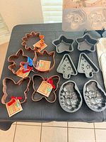 Copper cutters, star pans, tree pans, pinecone molds, novelty mold visible