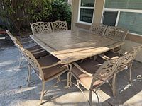 full dining set showing table and eight chairs
