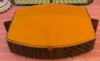 Top view of bun warmer with orange fabric lid