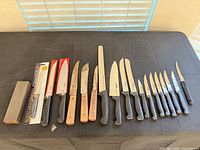 Full lot showing stone, three packaged knives, fifteen loose knives