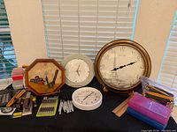 Overall view of four clocks and grouped office supplies