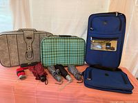 Group shot of all luggage pieces, umbrellas, and travel pouch