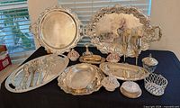 Overall view of all silver-plated serving pieces and porcelain centerpieces