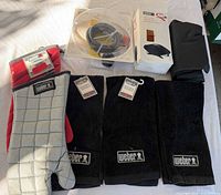 Lot overview: boxed grill cover, hose kit, two mitts, three towels