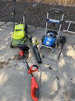 Group shot of mower, blower, trimmer, pressure washer with wand and hose