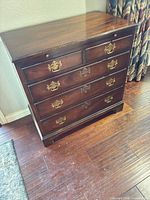 Front view of mahogany bachelor's chest showing six drawers and brass hardware