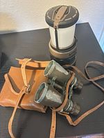 Lantern, binoculars and leather case overview