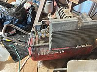 Full view of Craftsman air compressor showing tank, motor shroud, gauges, handle and wheels